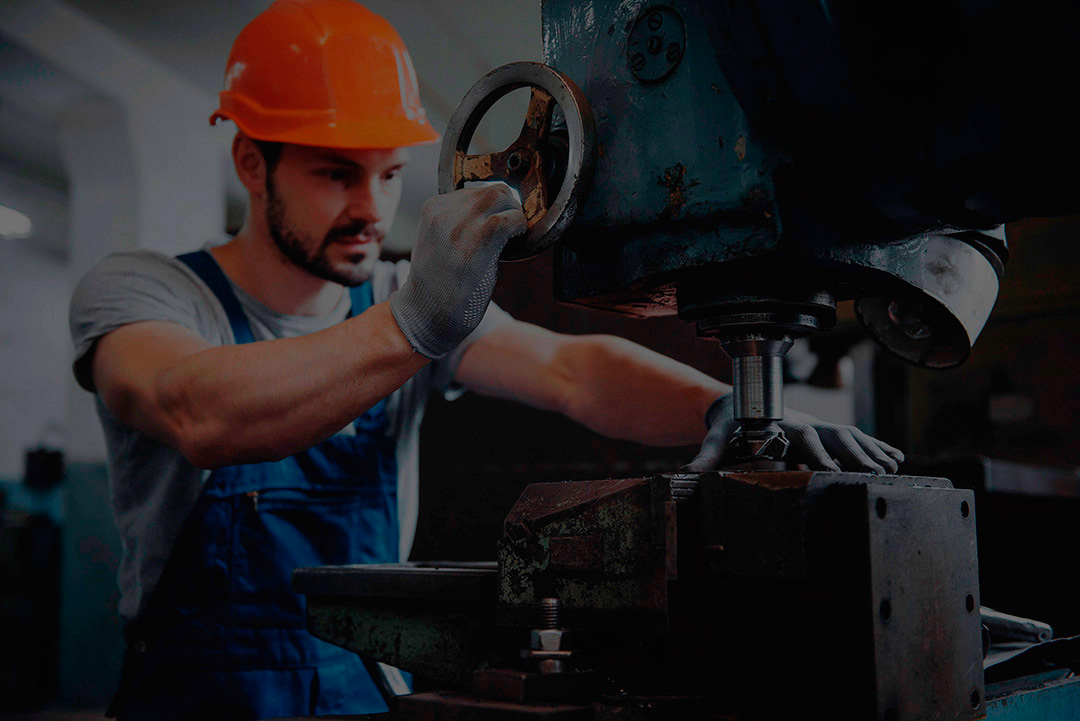 An industrial worker in a factory setting, symbolizing operations in motion.