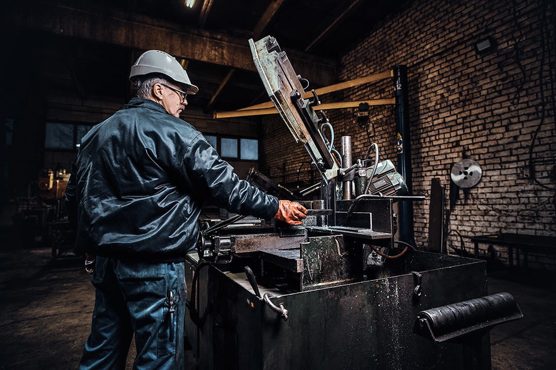An engineer inspecting equipment in a large industrial plant.